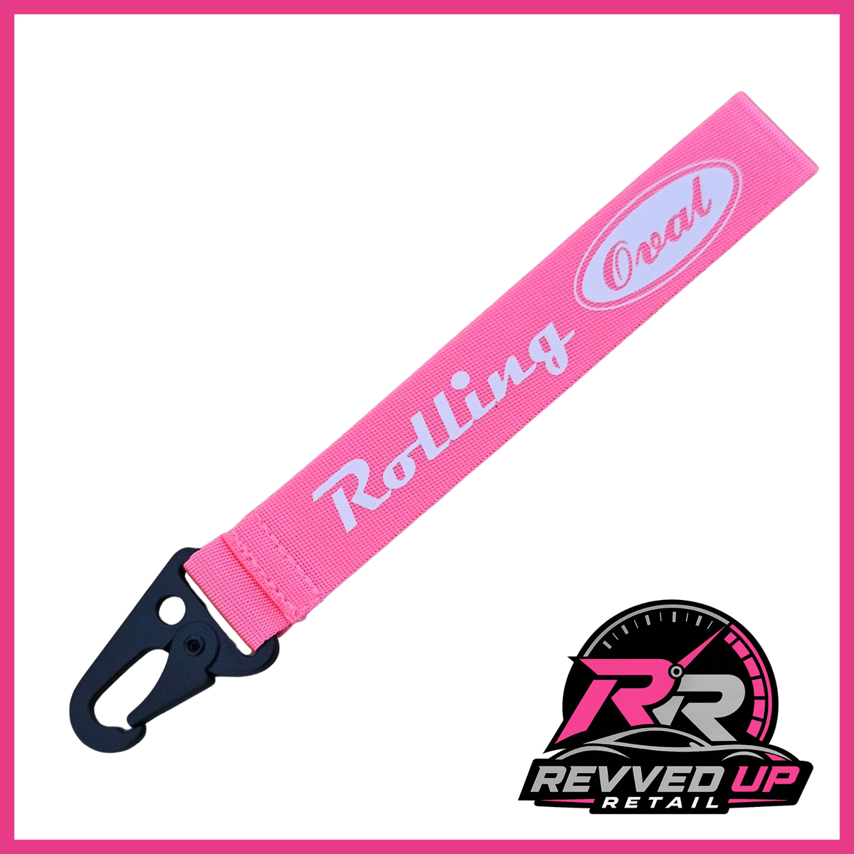 A Rolling Oval brand wristlet strap in fuchsia pink with white printed logos and a black metal carabiner clip, shown on a white background with a Revved Up Retail watermark.