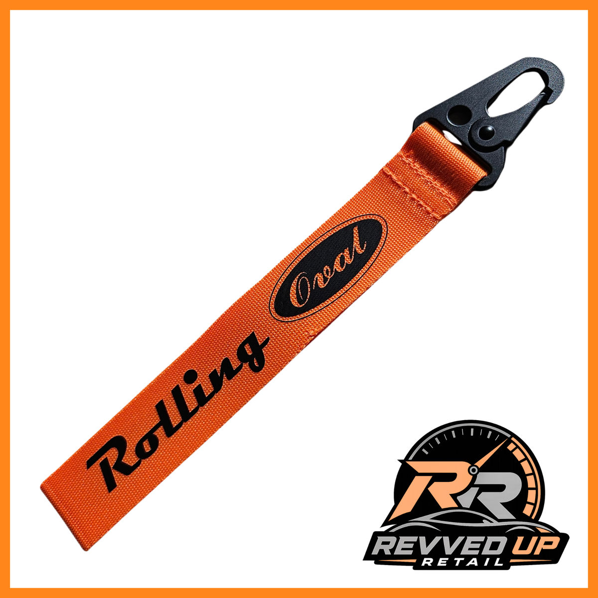 A Rolling Oval brand wristlet strap in orange with black printed logos and a black metal carabiner clip, shown on a white background with a Revved Up Retail watermark.