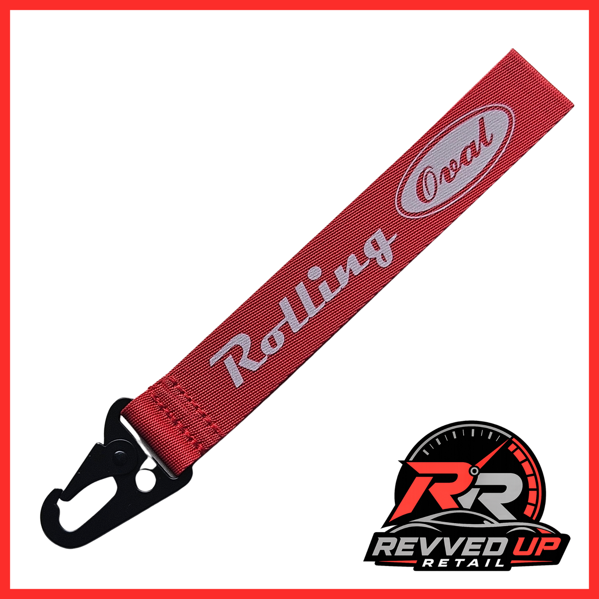 A Rolling Oval brand wristlet strap in red with grey printed logos and a black metal carabiner clip, shown on a white background with a Revved Up Retail watermark.