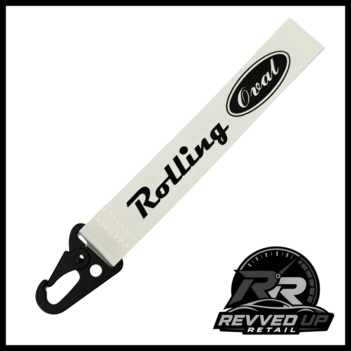 A Rolling Oval brand wristlet strap in white with black printed logos and a black metal carabiner clip, shown on a white background with a Revved Up Retail watermark.
