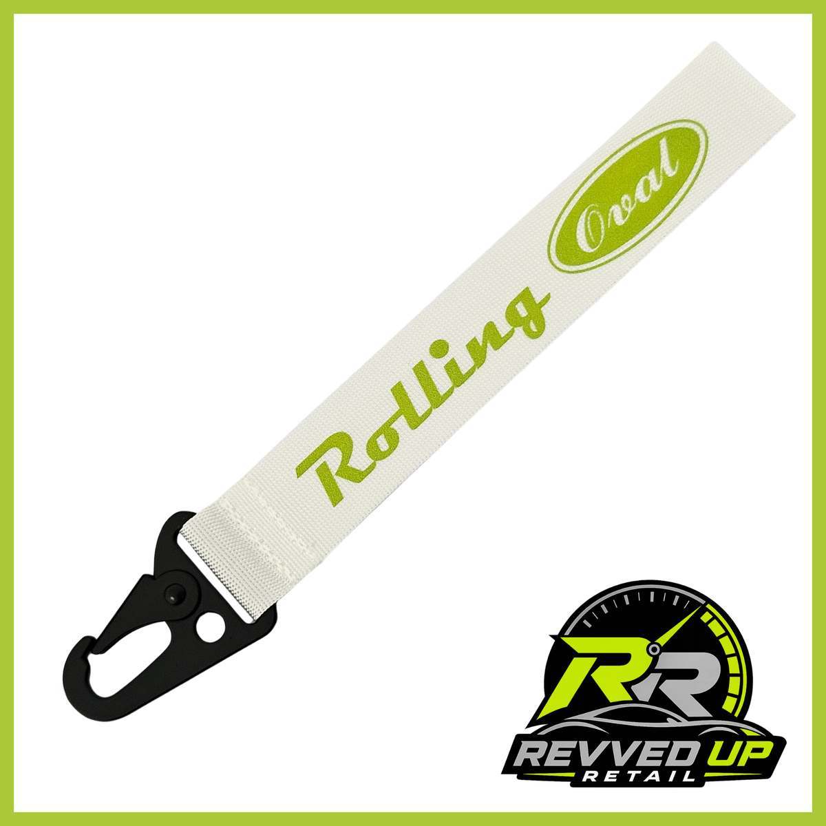 A Rolling Oval brand wristlet strap in white with green printed logos and a black metal carabiner clip, shown on a white background with a Revved Up Retail watermark.