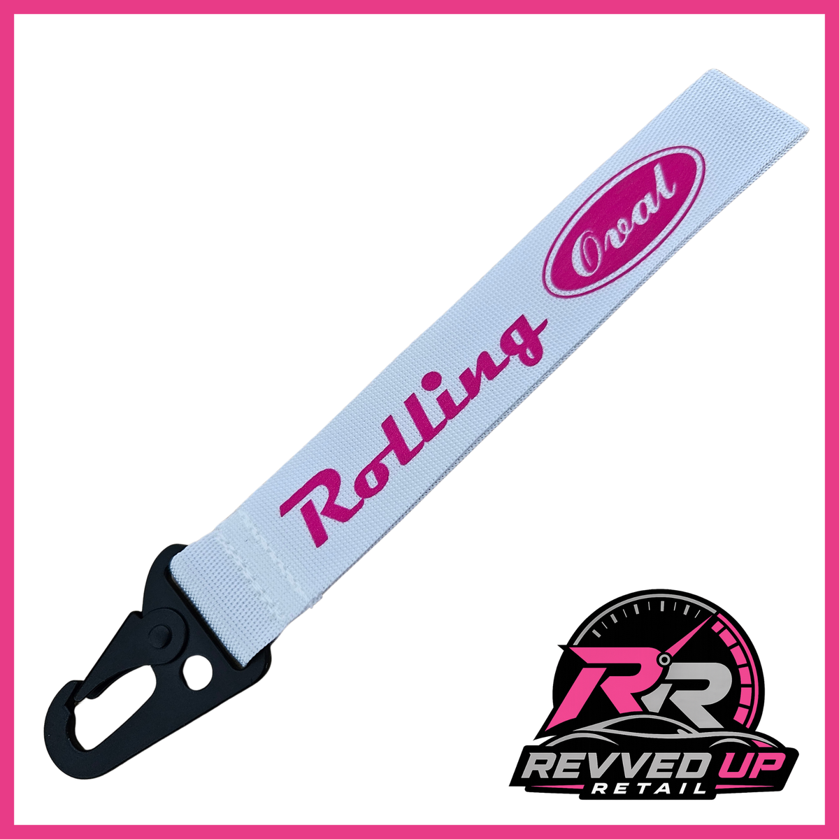 A Rolling Oval brand wristlet strap in white with hot pink printed logos and a black metal carabiner clip, shown on a white background with a Revved Up Retail watermark.
