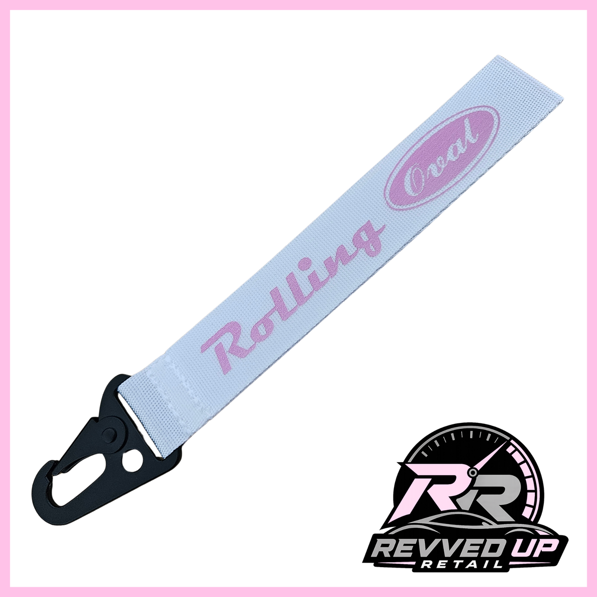 A Rolling Oval brand wristlet strap in white with pale pink printed logos and a black metal carabiner clip, shown on a white background with a Revved Up Retail watermark.