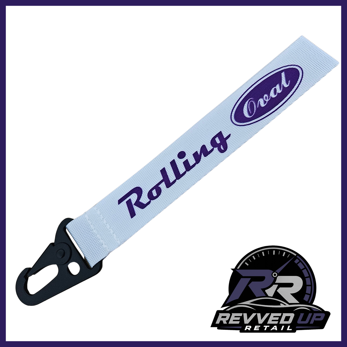 A Rolling Oval brand wristlet strap in white with purple printed logos and a black metal carabiner clip, shown on a white background with a Revved Up Retail watermark.