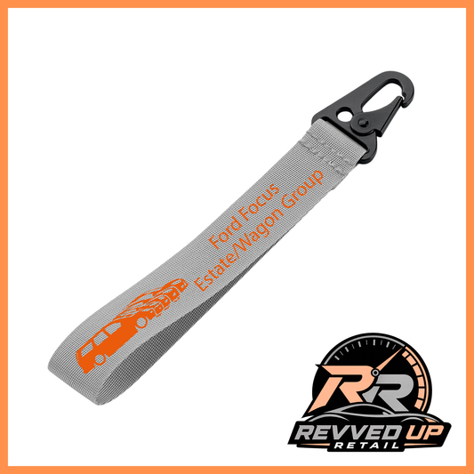 A Ford Focus Estate/Wagon Group brand wristlet strap in grey with orange printed logos and a black metal carabiner clip, shown on a white background with a Revved Up Retail watermark.