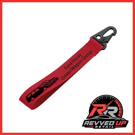 A Ford Focus Estate/Wagon Group brand wristlet strap in red with black printed logos and a black metal carabiner clip, shown on a white background with a Revved Up Retail watermark.