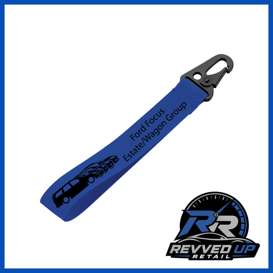 A Ford Focus Estate/Wagon Group brand wristlet strap in royal blue with black printed logos and a black metal carabiner clip, shown on a white background with a Revved Up Retail watermark.